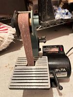 Front view of Delta belt sander showing belt, work table, and motor housing