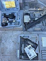 All three nailers in their cases