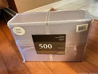 Front view sealed package showing 500 tc and Queen label