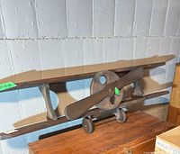 Front view of wooden biplane shelf showing overall design