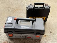 Closed DeWalt drill case and closed Eureka ToolBox Vac
