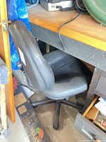 full view of chair under desk showing seat, backrest and base