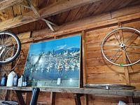 Framed print leaning on shelf with two visible steering wheels