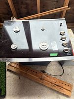 Angled top view of GE gas cooktop showing burners and control knobs
