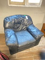 Front view of black leather armchair