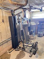 Full view of Marcy multi-station home gym showing weight stack, frame, bench, and lat pulldown bar