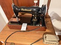 overall view of Piedmont sewing machine on wooden base with foot pedal