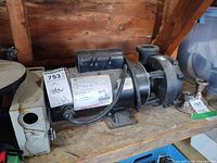 Side view of Magnetek/Century Lasar pump motor showing label, pump housing, base mount and power cord