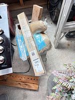 Overview showing boxed bracket, burlap wrap, scrap wood and edge of cooktop