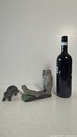 Walrus and bear soapstone carvings beside wine bottle