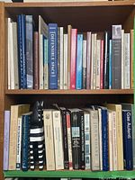 Two shelves filled with architecture books, top and bottom rows