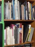 Two shelves filled with architecture books, spines outward