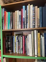 Upper shelf of Toronto-themed books, hardcovers and paperbacks