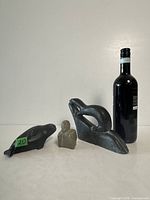 Group shot with wine bottle for scale showing all three soapstone carvings