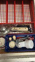 Drawer with steak knives, ladle, plastic containers, measuring cup