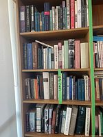Full view of four shelves packed with assorted books