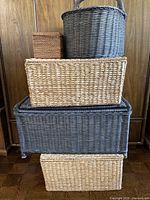 Front view of stacked five woven baskets showing sizes and colors