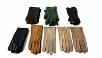 Eight pairs assorted leather gloves displayed flat