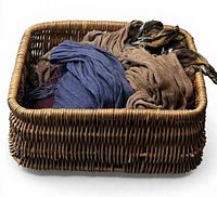 Wicker basket filled with assorted linen scarves
