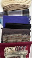 Stack of nine assorted scarves showing colours and patterns