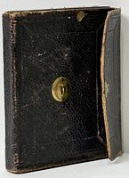 Closed black leather case standing upright