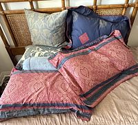Assorted pillows on bed showing colors, patterns and sizes