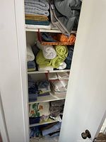 Full closet view with towels and folded linens