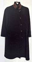Full frontal view of the black wool coat showing length and button arrangement
