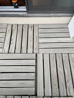 Close view of wooden slatted deck tiles showing construction and finish
