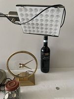 Lamp, clock, wine bottle for scale