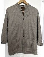 Front view of light brown quilted jacket on hanger