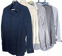Five shirts hung on hangers showing colors and styles