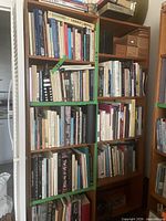 Front view of the two-piece bookshelf filled with books