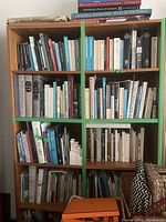 Front view of the paired wooden bookcases filled with books