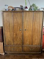 Front view of closed wardrobe showing wood veneer finish and hardware