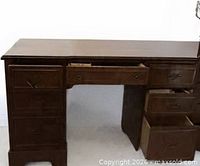 Full view of solid wood desk, drawers partly open