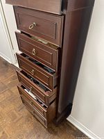 Full view of narrow 7-drawer chest showing ring pulls and drawers