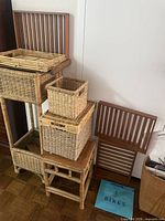 overall view of stacked wicker planter stands, baskets and wooden slat backs
