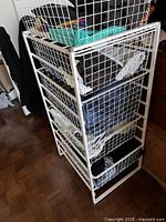 Freestanding white metal basket tower with five drawers