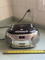 Front view showing CD lid, cassette door, speakers and power cord