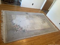 Full view of large rectangular rug on hardwood floor