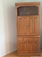 full view of assembled two-piece maple entertainment cabinet