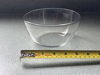 Side view of clear glass bowl with measuring tape showing diameter ~6 in