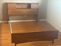 Overall view of assembled bed frame with storage headboard and footboard