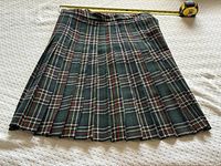 Full view of pleated kilt laid flat showing pattern and pleats