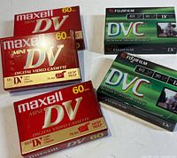 Five sealed Mini DV tapes, three Maxell and two Fujifilm, front packaging visible