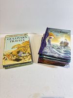Stack of five Ladybird Classics hardcovers beside stack of six padded softcovers; Gulliver’s Travels visible