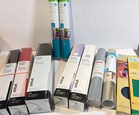 Assorted Cricut vinyl, iron-on, transfer tape and Infusible Ink packages