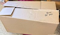 Closed cardboard box marked approx 55 VHS