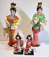 Front view of all four Japanese dolls showing size difference and outfits